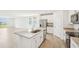 Open-concept kitchen featuring granite countertops, stainless steel appliances, and a center island at 31653 Wild Grape Ln, Brooksville, FL 34602