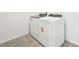Convenient laundry area with modern, white front-loading washer and dryer units at 31653 Wild Grape Ln, Brooksville, FL 34602