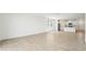 Open-concept living area boasts neutral tile flooring and seamlessly flows into the kitchen at 31653 Wild Grape Ln, Brooksville, FL 34602