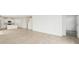 Spacious living area with tile flooring leading to the kitchen with stainless appliances at 31653 Wild Grape Ln, Brooksville, FL 34602