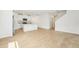 Open concept living and kitchen area with tile flooring and white walls and cabinetry at 31653 Wild Grape Ln, Brooksville, FL 34602