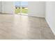 Bright living room features light gray tile floors, recessed lighting and a glass sliding door to the yard at 31653 Wild Grape Ln, Brooksville, FL 34602