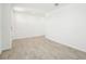 Spacious living room featuring neutral tile flooring and bright white walls at 31653 Wild Grape Ln, Brooksville, FL 34602