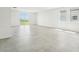 Bright living room features light gray tile floors, recessed lighting and a glass sliding door to the yard at 31653 Wild Grape Ln, Brooksville, FL 34602