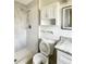 Updated bathroom featuring a tiled shower, toilet, vanity, and mirrored medicine cabinet at 322 Hoffman Blvd, Tampa, FL 33612