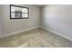 Empty room with neutral walls, tile floor, and a black-framed window at 322 Hoffman Blvd, Tampa, FL 33612