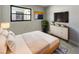 Cozy bedroom with a plush bed, modern dresser, television, and stylish decor at 322 Hoffman Blvd, Tampa, FL 33612