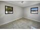 Empty room with neutral walls, tile floor, and black-framed windows at 322 Hoffman Blvd, Tampa, FL 33612