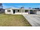 Charming single-story home featuring a covered parking area and a well-maintained front lawn at 322 Hoffman Blvd, Tampa, FL 33612