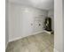 Utility room with tile floors, water heater and storage shelves at 322 Hoffman Blvd, Tampa, FL 33612