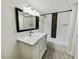 Elegant bathroom featuring modern fixtures, a stylish vanity, and a beautifully tiled shower and tub at 4907 E Clifton St, Tampa, FL 33610