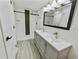 Modern bathroom features dual vanity with sleek fixtures and a tiled shower at 4907 E Clifton St, Tampa, FL 33610