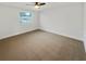 Simple bedroom with cozy carpet and bright natural light showcasing a minimalist style at 4907 E Clifton St, Tampa, FL 33610