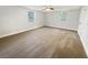 Bright bedroom features neutral carpet, two windows, and a ceiling fan at 4907 E Clifton St, Tampa, FL 33610