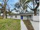 Beautiful home featuring a well-kept lawn and mature trees creating a welcoming and picturesque scene at 4907 E Clifton St, Tampa, FL 33610