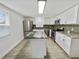 Modern kitchen with stainless steel appliances, granite countertops, and a stylish island at 4907 E Clifton St, Tampa, FL 33610