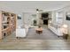 Bright living room with stylish striped rug, stone fireplace, and modern furniture at 4907 E Clifton St, Tampa, FL 33610
