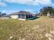Expansive backyard view featuring a screened-in lanai offering relaxation and outdoor enjoyment at 6191 Silverdale Ave, Spring Hill, FL 34608