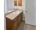 Bathroom features a vanity with cabinets, large mirror, and white sink with faucet at 6191 Silverdale Ave, Spring Hill, FL 34608