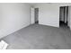 Clean bedroom featuring neutral carpeting, closet, and ample space at 6191 Silverdale Ave, Spring Hill, FL 34608