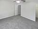 A neutral bedroom offers comfort with soft gray carpeting and ceiling fan with attached light at 6191 Silverdale Ave, Spring Hill, FL 34608