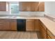 Functional kitchen with wooden cabinetry, a double sink, and ample countertop space at 6191 Silverdale Ave, Spring Hill, FL 34608