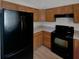 Functional kitchen featuring wooden cabinets, black appliances, and ample counter space at 6191 Silverdale Ave, Spring Hill, FL 34608