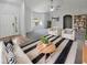 Bright living room showcasing neutral walls, plush seating, stylish rug, ceiling fan, and ample natural light at 6191 Silverdale Ave, Spring Hill, FL 34608