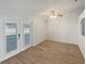 Bright room with natural light features luxury vinyl plank flooring and double glass doors to lanai at 6191 Silverdale Ave, Spring Hill, FL 34608