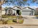 Charming single-story home with a well-manicured lawn, two-car garage, and neutral gray color scheme at 6721 Somerset Garden Way, Apollo Beach, FL 33572