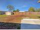 Large backyard features a wooden fence and a storage shed at 6804 11Th W St, Bradenton, FL 34207