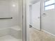 Bathroom interior showcasing a shower with a seat and a towel ring next to the door at 6804 11Th W St, Bradenton, FL 34207