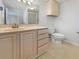 Bathroom features a vanity with storage, a large mirror, and a toilet at 6804 11Th W St, Bradenton, FL 34207
