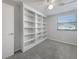 Cozy bedroom with a built-in bookshelf, a ceiling fan and a window at 6804 11Th W St, Bradenton, FL 34207