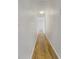 Long hallway with wood-look floors and a simple lighting fixture at 6804 11Th W St, Bradenton, FL 34207
