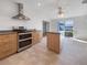 Contemporary kitchen featuring stainless steel appliances, an island and tile floors at 6804 11Th W St, Bradenton, FL 34207