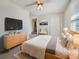 Bright main bedroom featuring a TV, dresser, a closet, and neutral colored walls at 6804 11Th W St, Bradenton, FL 34207