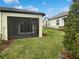 Private screened lanai overlooking a manicured backyard at 6856 Ripple Pond Loop, Zephyrhills, FL 33541