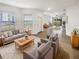 Bright living room featuring neutral walls, tile floors and a comfortable seating area at 6856 Ripple Pond Loop, Zephyrhills, FL 33541