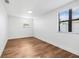Bright bedroom featuring wood-look flooring, a ceiling fan, and bright windows at 5980 32Nd N Ave, St Petersburg, FL 33710