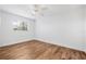 Cozy bedroom showcasing wood-look flooring, a ceiling fan, and a bright window at 5980 32Nd N Ave, St Petersburg, FL 33710