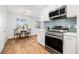 Bright kitchen features stainless steel appliances and a cozy breakfast nook with wood floors at 5980 32Nd N Ave, St Petersburg, FL 33710