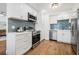 Clean kitchen with white cabinetry, stainless steel appliances and stylish tile backsplash at 5980 32Nd N Ave, St Petersburg, FL 33710