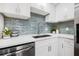 Modern kitchen features stainless steel appliances and beautiful backsplash at 5980 32Nd N Ave, St Petersburg, FL 33710