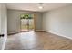 Bedroom with sliding glass doors leading to outdoor space and sleek wood-look floors at 6262 142Nd N Ave # 1203, Clearwater, FL 33760