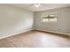 Cozy bedroom featuring wood-look floors and a window providing natural light at 6262 142Nd N Ave # 1203, Clearwater, FL 33760