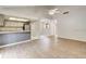 Bright, open living room with hardwood floors, ceiling fan, and access to kitchen and dining areas at 6262 142Nd N Ave # 1203, Clearwater, FL 33760