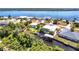 Beautiful waterfront property with lush landscaping, a boat dock, and stunning water views, outlined in red at 3215 Peace River Dr, Punta Gorda, FL 33983