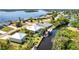 Scenic aerial view of a waterfront property featuring a pool, boat dock, and lush surroundings, property outlined in red at 3215 Peace River Dr, Punta Gorda, FL 33983