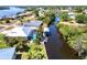 Aerial view of a waterfront property with a dock and boat lift on a canal with views of the open bay. Property outlined in red at 3215 Peace River Dr, Punta Gorda, FL 33983